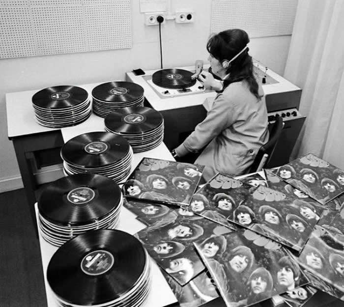 Listening to copies of The Beatles &ldquo;Rubber Soul&rdquo; in the Quality Control room at the EMI pressing plant in London, England, 1965