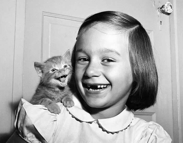 A girl and her cat, 1955. - Animals Stole the Spotlight Historic Photos