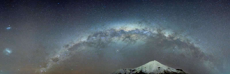 Mobile Nighttime Photography - Third Place: Milky Way Arch with LMC and SMC over Taranaki Maunga by Nikita Veerabahu Pillai  - 2026 Capture the Dark photography contest Winners