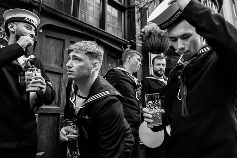 1st Place Winner: From Salute to Cheers by Chris Mozyro, United Kingdom - Pure Street Photography 2026 Winners