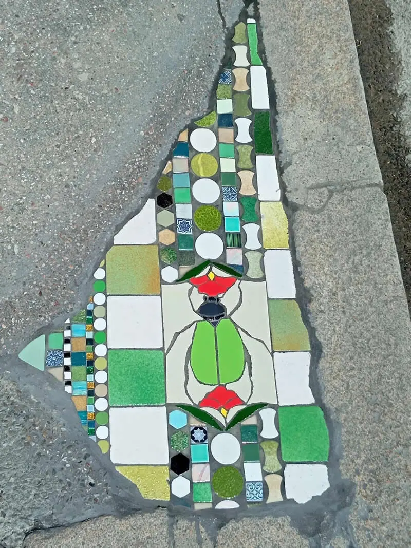 Floral mosaic adorned with a beautiful scarab beetle.