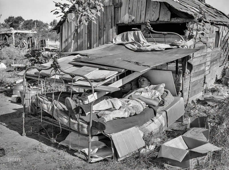 40 Historic Photos That Will Completely Change How You See the Past 49 A man rests in a bed with roof over it. Mays Avenue camp, Oklahoma City, Oklahoma. (Photo by Russell Lee).