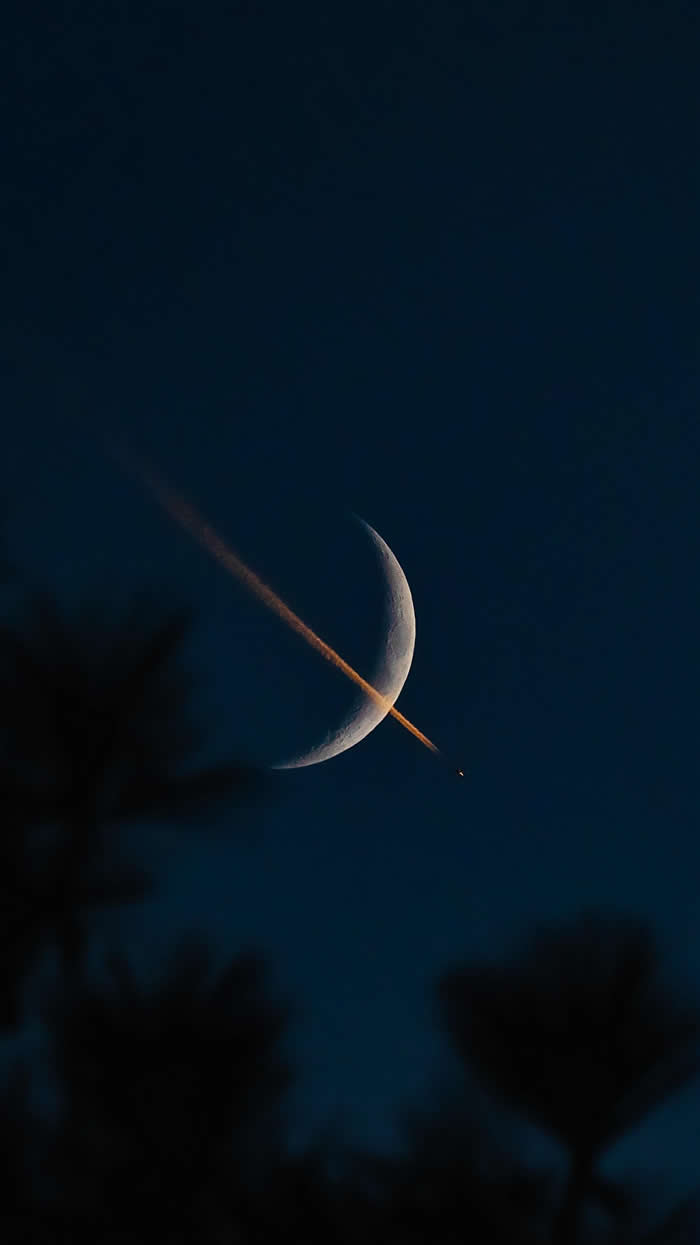 ITAP of a plane transiting a waxing crescent moon at sunset
