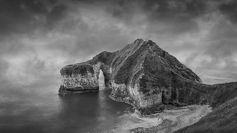 Earth in Elegant Monochrome: 40 Landscape Winners From the MonoVisions Awards 2026 77 The Drinking Dino: Flamborough by Simon Vaughan, United Kingdom - MonoVisions Black and White Awards Landscape 2026 Winners