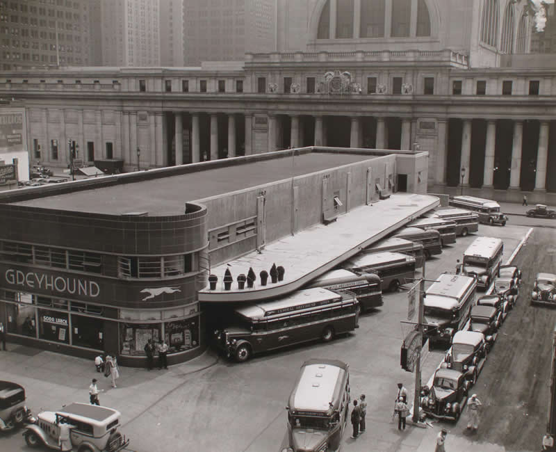 Greyhound Bus Terminal, 33rd and 34th Streets between Seventh and Eighth Avenues, Pennsylvania Station in background, Manhattan, 1936. Photograph by Berenice Abbott.