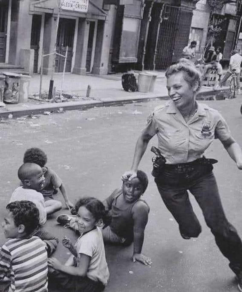NYPD policewoman playing duck, duck, goose, 1970s.