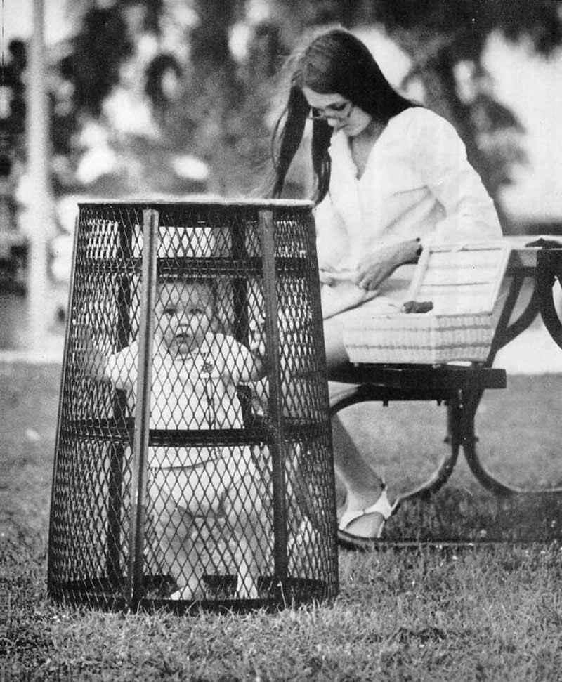 1969. Mom contains her Baby in a Central Park's Trash Bin while She catches up on Her Crocheting.