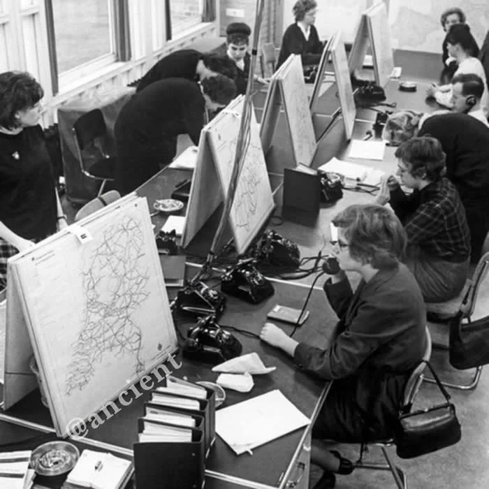 A pre-GPS era navigation hotline. Pictured: Operators giving directions to callers who would inquire about driving directions before they left their homes on a trip. (Netherlands, circa 1963). Photo by ANP