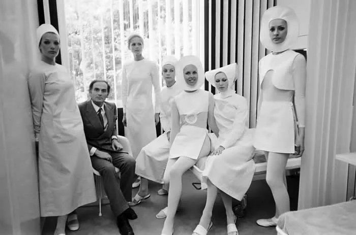 Fashion designer Pierre Cardin posing with Models in his futuristic vision of nursing uniforms in Paris, France in 1970.