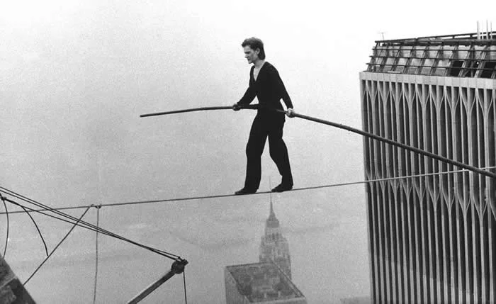 Philippe Petit walking across a tightrope between the World Trade Center's Twin Towers in 1974.