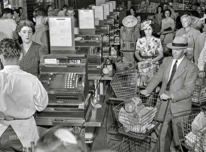 Wartime Rationing: Summer of 1942, Washington, DC. Cashiers checking out customer purchases with Ration Book No. 1 at the Giant Food shopping center on Wisconsin Avenue.