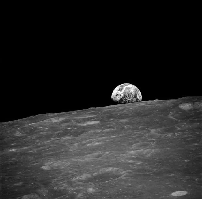 The first photograph of Earthrise, taken by astronaut William Anders during Apollo 8. 24 December 1968