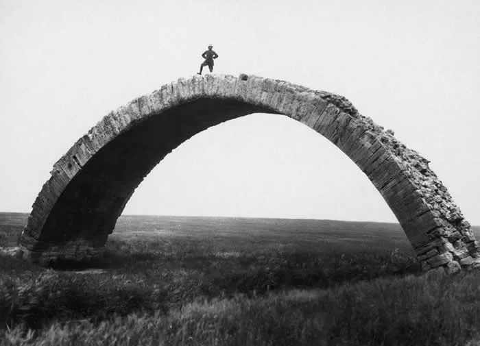 An old photo taken by Max van Oppenheim of an ancient Roman bridge that spans the Wadi al Murr near Mosul, Iraq, in the 1920s