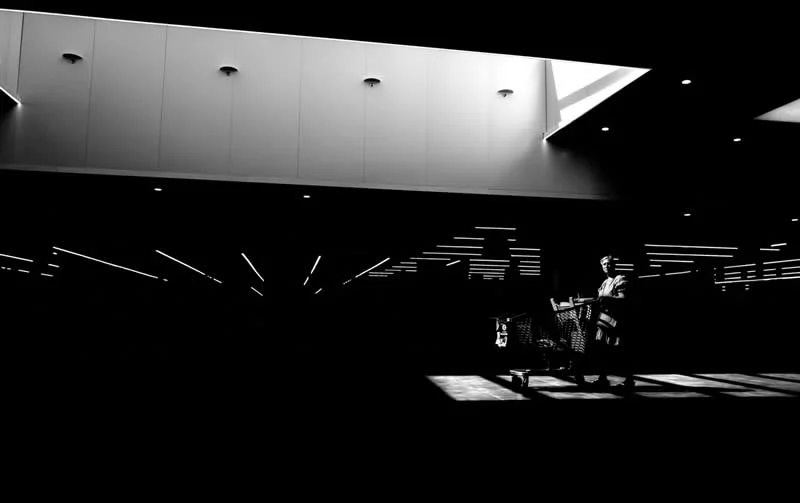 The light and shadows of consumers by Saligue R&eacute;mi, France - MonoVisions Awards 2026 Street Winners