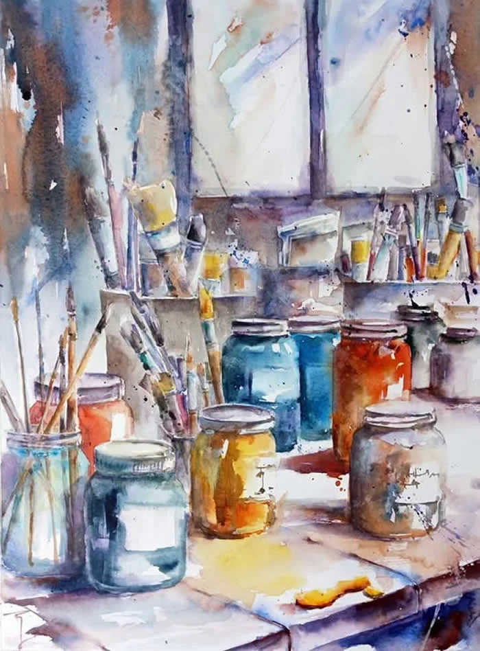 Watercolor painting by French artist Catherine Rey titled Canvas, depicting an artist&rsquo;s workspace with colorful paint jars, brushes, palettes, and canvases, rendered in expressive blue, orange, yellow, and earthy watercolor washes.